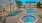 a swimming pool with chairs around it
