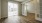 a room with a wood floor and white walls