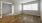 a room with a wood floor and white walls